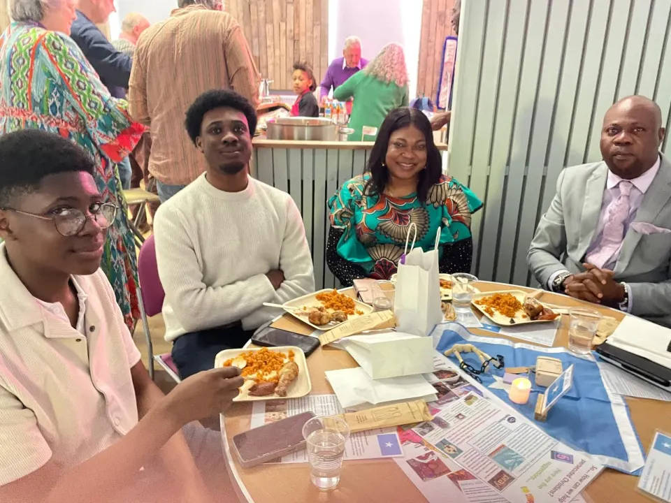 Sharing a meal at the Open Doors evening in April 2026.