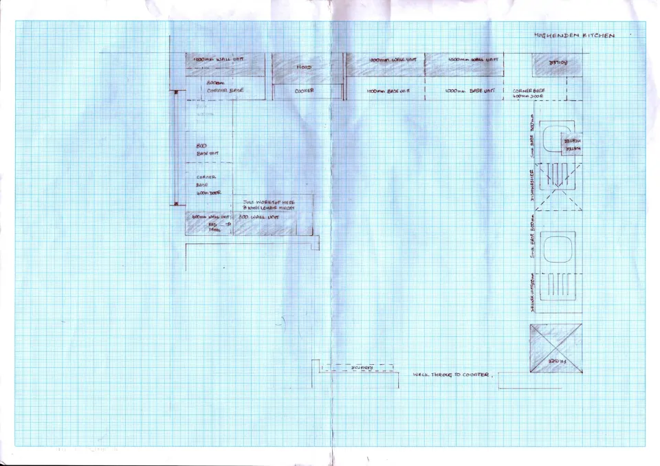 Kitchen plan on graph paper with cabinet runs and flow.