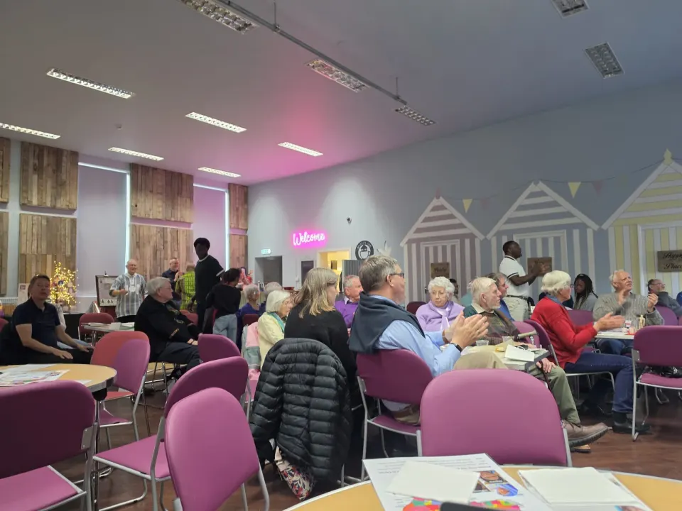 The community gathered at tables in the hall